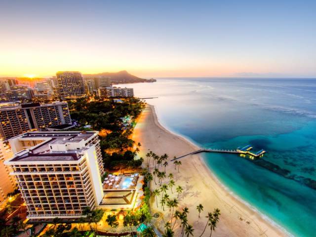 Waikiki Beach, Oahu, Hawaii-The iconic, crescent-shaped Waikiki Beach has a long history of being one of the most popular beach destinations in the US. Visitors can enjoy incredible views of Diamond Head Crater while sipping on a mai tai, or go for a surf lesson.