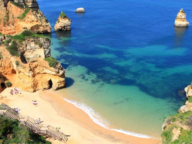 Praia Don Ana, Lagos, Portugal-This postcard-worthy beach may be small, but that doesn't mean it's not worth visiting. Nestled into the Algarve — a region that makes up Portugal's southernmost tip — Praia Dona Ana is bordered by towering cliffs that form caves, which you should by all means explore with a quick boat trip.