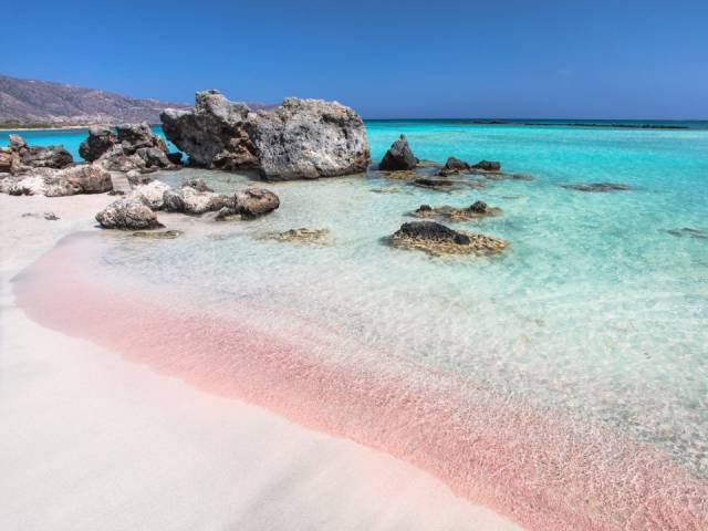 Elafonissi Beach, Crete, Greece-Elafonissi's stunning light pink sand is its main draw. Located on Crete's Southwestern side, the beach is great for visitors of all ages, thanks to its shallow waters