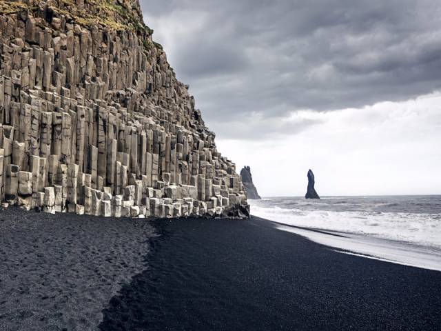 Reynisfjara Beach, Vik, Iceland-You probably won't want to sunbathe on Reynisfjara, but that doesn't mean it's not worth a visit. The stunning beach looks otherworldly thanks to its black sand, basalt stone columns, and the fog that sometimes envelops it. If you're lucky, you might even catch a glimpse of the Northern Lights.