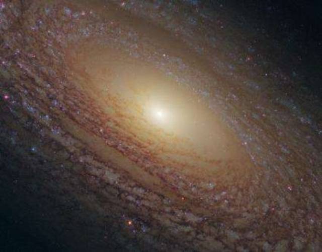 The Flocculent Spiral-Unlike our galaxy, NGC 2841 has much shorter spiral arms rather than long extensive limbs and is therefore known as a flocculent galaxy.