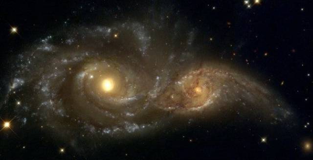 Colliding Galaxies-Just like anything else in the universe, galaxies can collide into one another. The two captured above will eventually come to form one elliptical galaxy, but the process will probably take over a billion years.