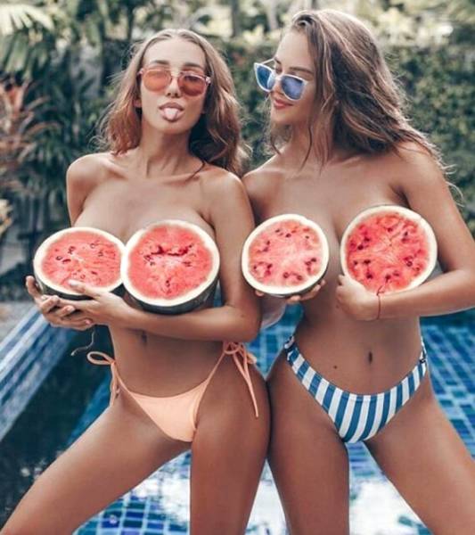 girls in bikinis holding watermelons over their chest
