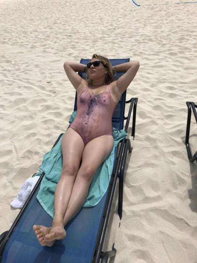 woman on the beach wearing man skin bathing suit