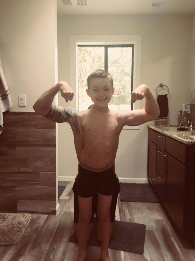 kids showing off his muscles