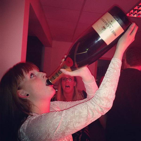 woman drinking large bottle of wine