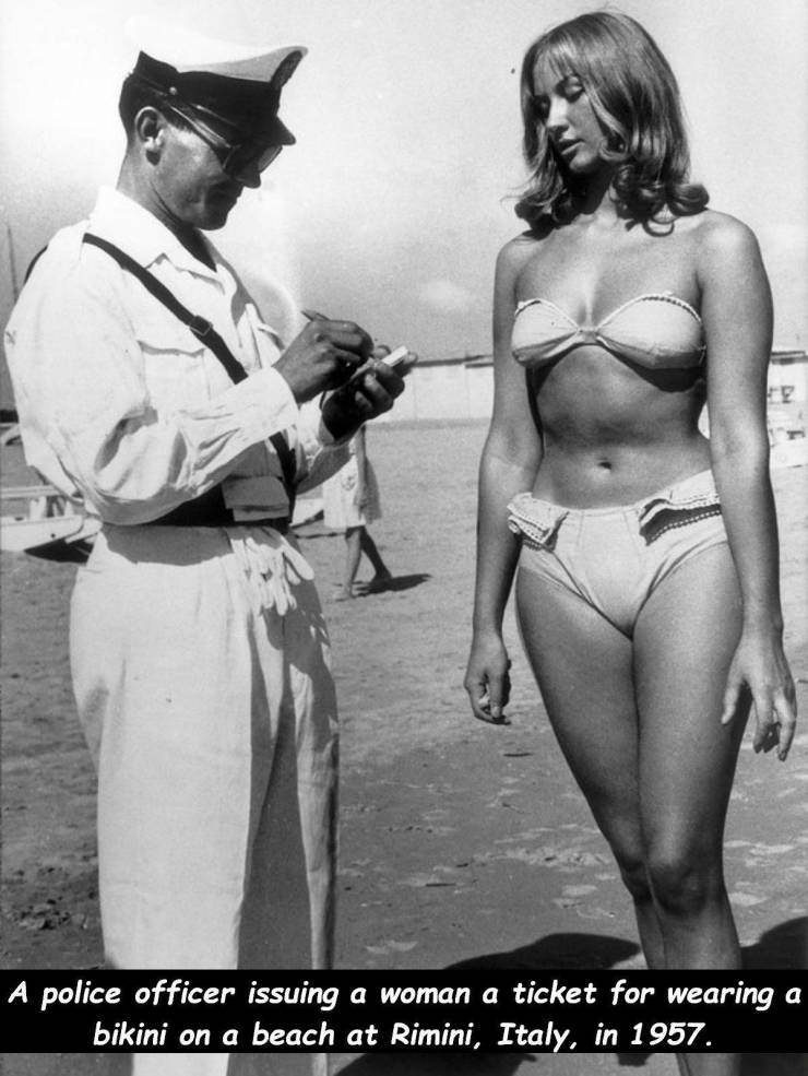 bikini rimini - A police officer issuing a woman a ticket for wearing a bikini on a beach at Rimini, Italy, in 1957.