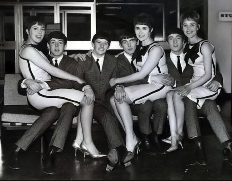 the Beatles with girls on their laps