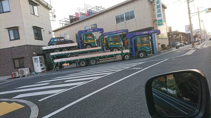 a truck carrying a bunch of smaller versions of itself on top of eachother