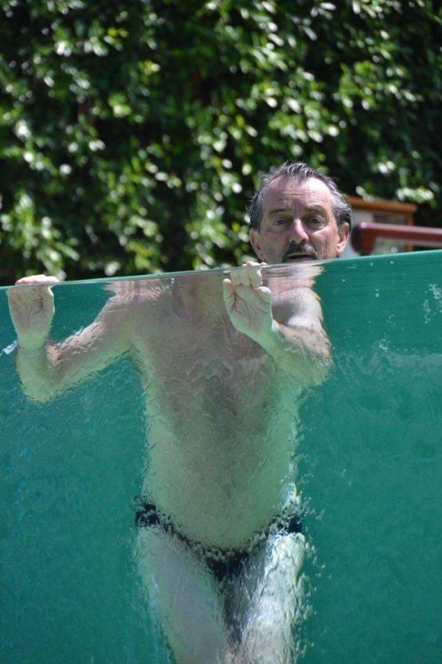 man in pool refraction
