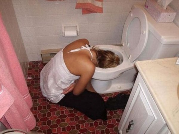 girl puking in toilet