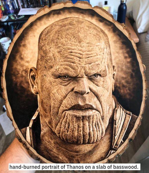 head - handburned portrait of Thanos on a slab of basswood.