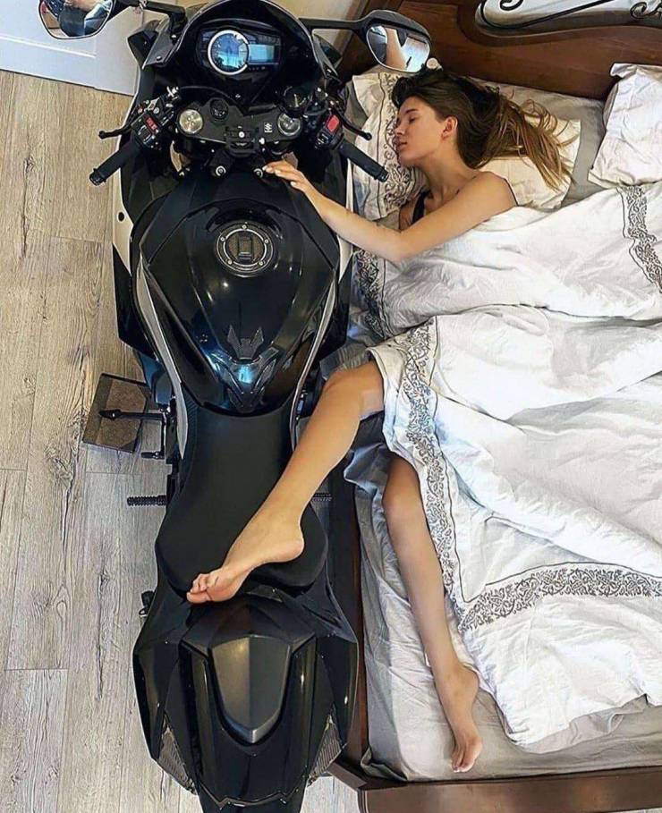 woman snuggling in bed with a Motorcycle