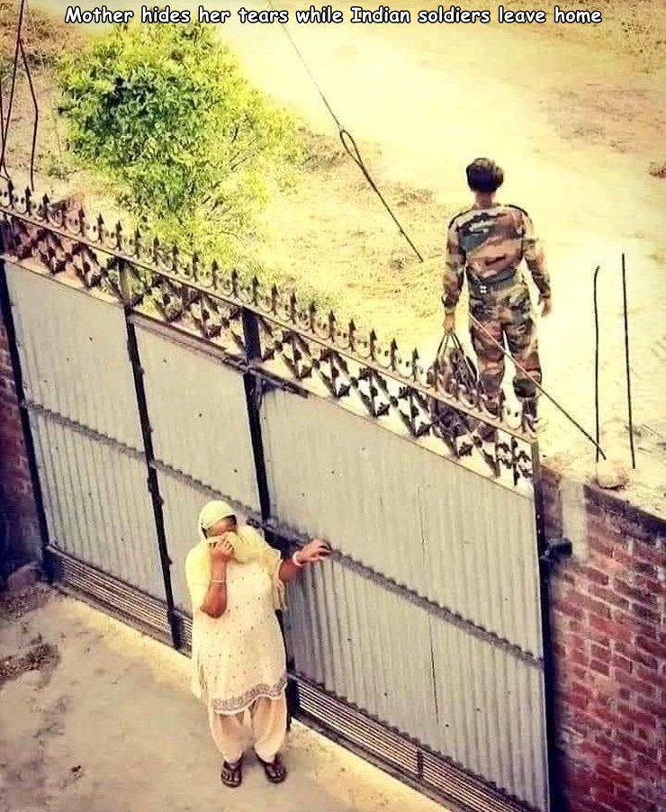 wall - Mother hides her tears while Indian soldiers leave home