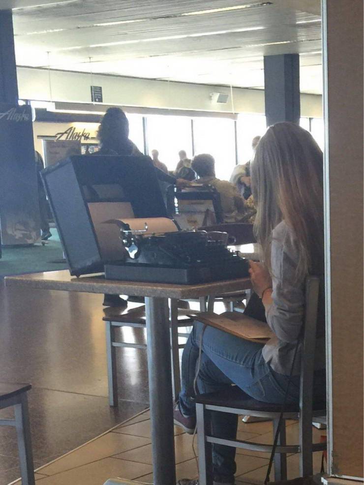 woman with typewriter in airport