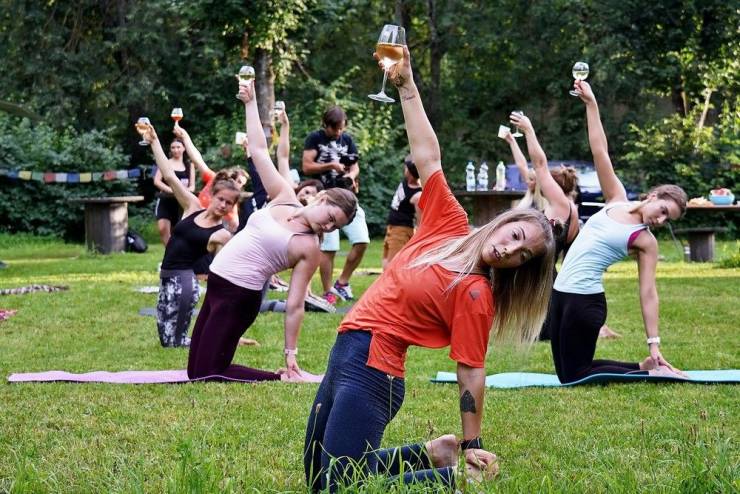 women doing yoga while drinking wine