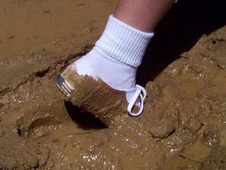 white shoe and socks covered in mud