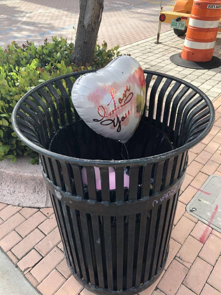 balloon that says I love you inside a trash can