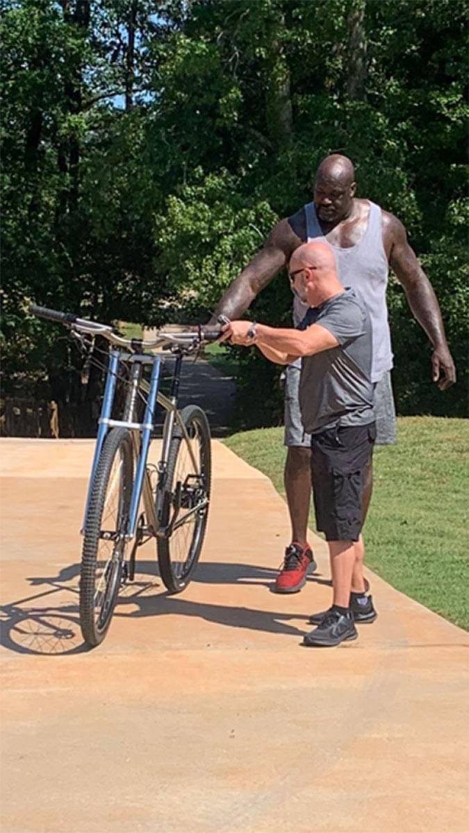 funny meme - shaq showing off his really tall bicycle
