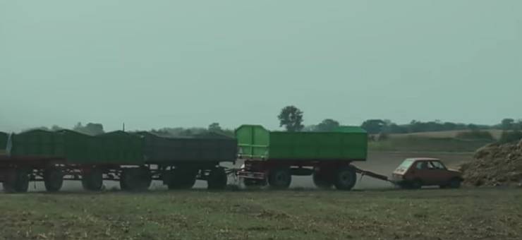 tiny car towing huge trailers