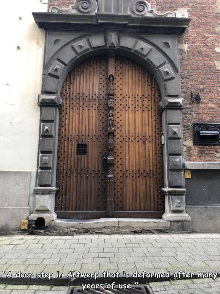 iron - "A door step in Antwerp that is deformed after many years of use."