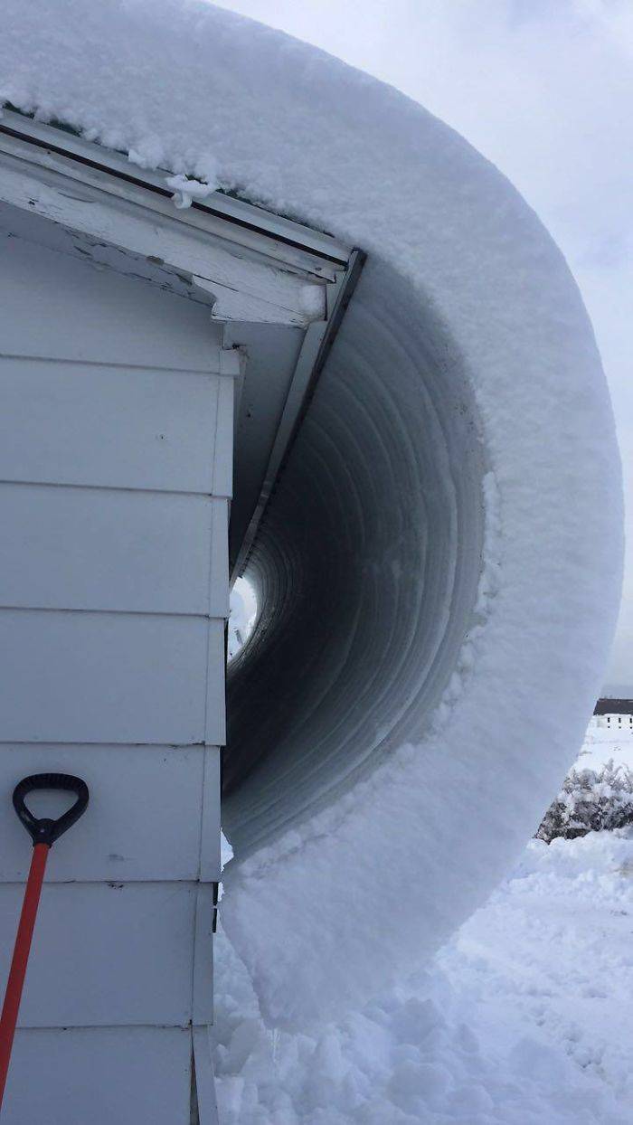 snow curling off roof