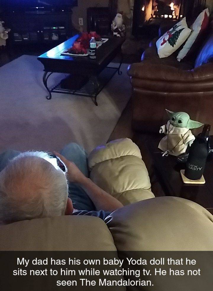 photo caption - My dad has his own baby Yoda doll that he sits next to him while watching tv. He has not seen The Mandalorian.
