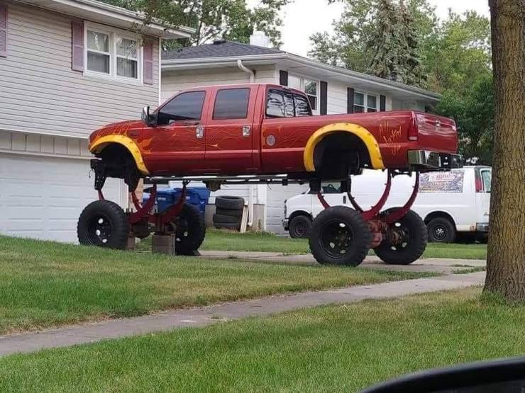 funny pictures - red pick up truck on super raised suspension