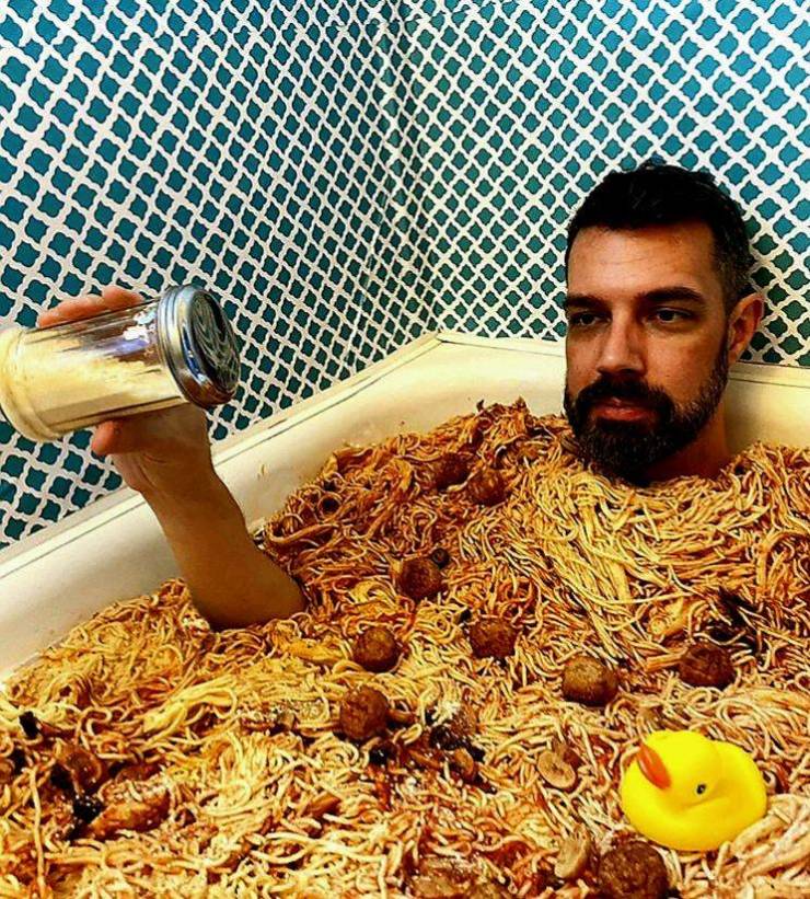 funny pictures - guy sitting in bathtub full of spaghetti and meatballs