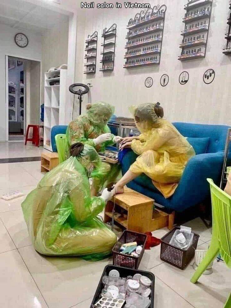 cool pics - Nail salon in Vietnam everyone is wearing full body plastic coverings