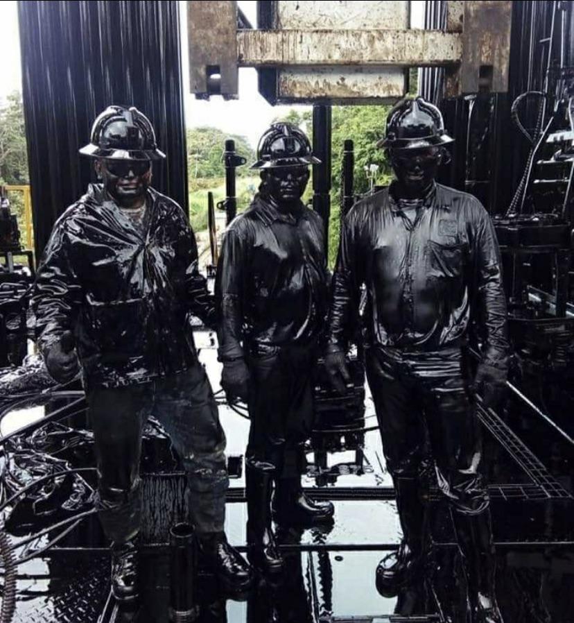 cool pics - Oil well spill workers covered in oil