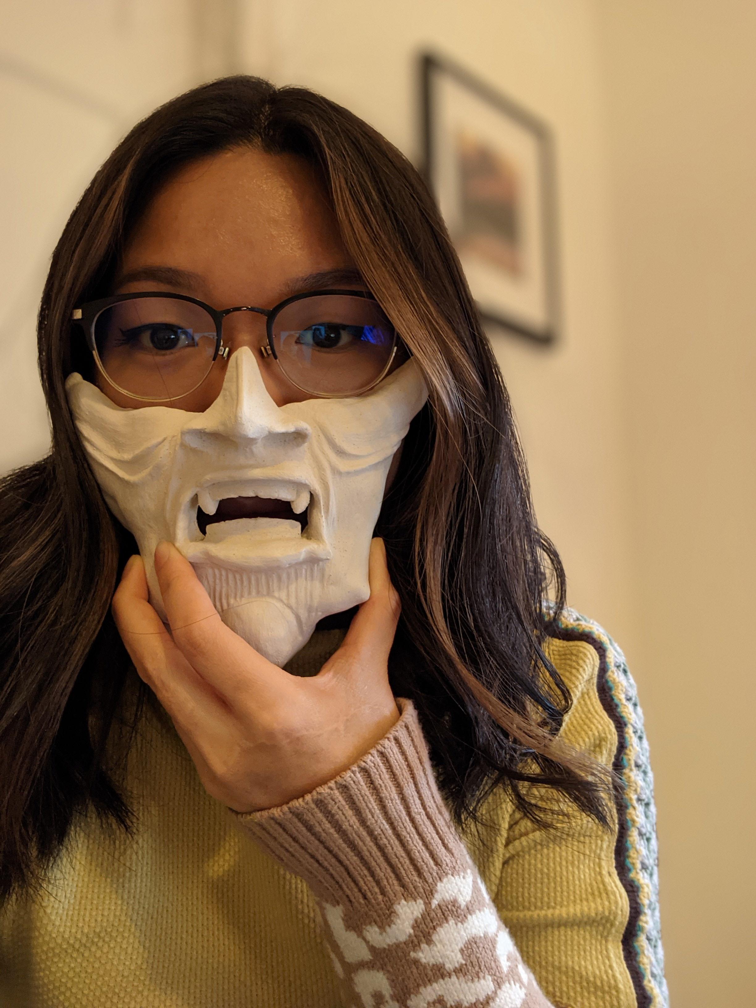 cool pics - woman holding porcelain facemask