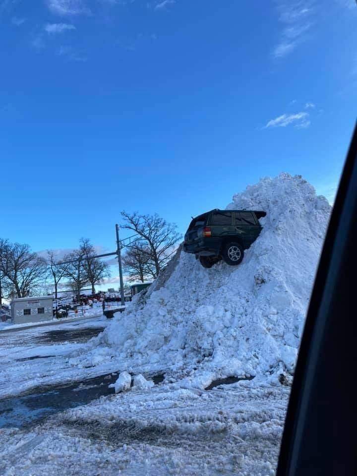 cool funny pics - car stuck up high in pile of snow