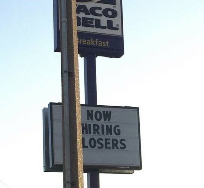 street sign - Aco Bell Breakfast Now Hiring Losers