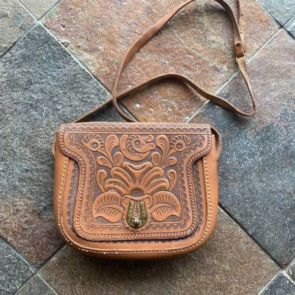 “Paid $3.99 for this gorgeous 1950s tooled leather bag.”