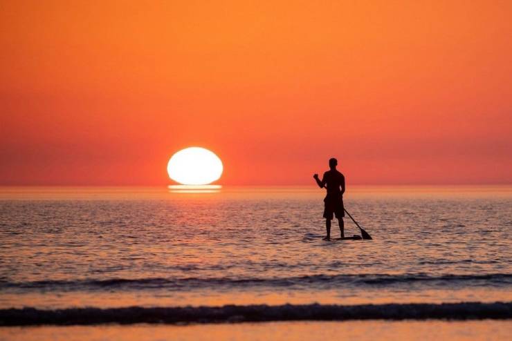 roy riley paddle boarder sunset
