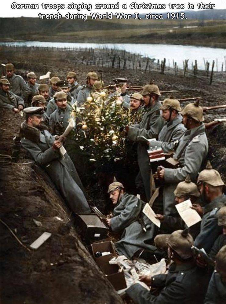 christmas in the trenches - German troops singing around a Christmas tree in their french during World War I, circa 1915.
