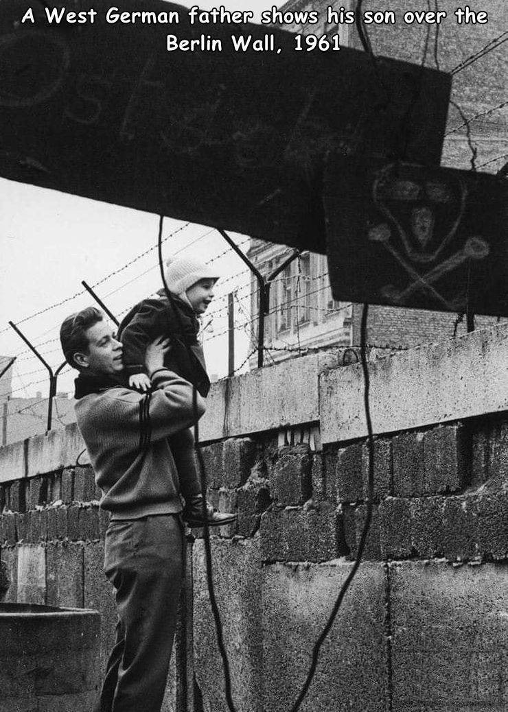 cool random photos - berlin wall construction - A West German father shows his son over the Berlin Wall, 1961