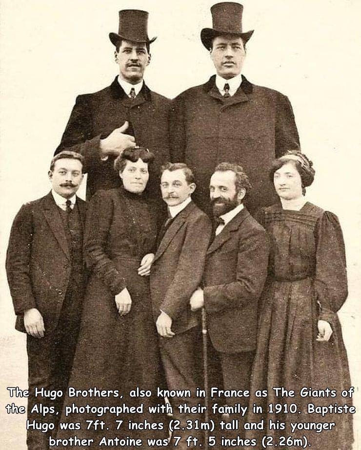 cool random photos - familial isolated pituitary adenoma - The Hugo Brothers, also known in France as The Giants of the Alps, photographed with their family in 1910. Baptiste Hugo was 7ft. 7 inches 2.31m tall and his younger brother Antoine was 7 ft. 5 in