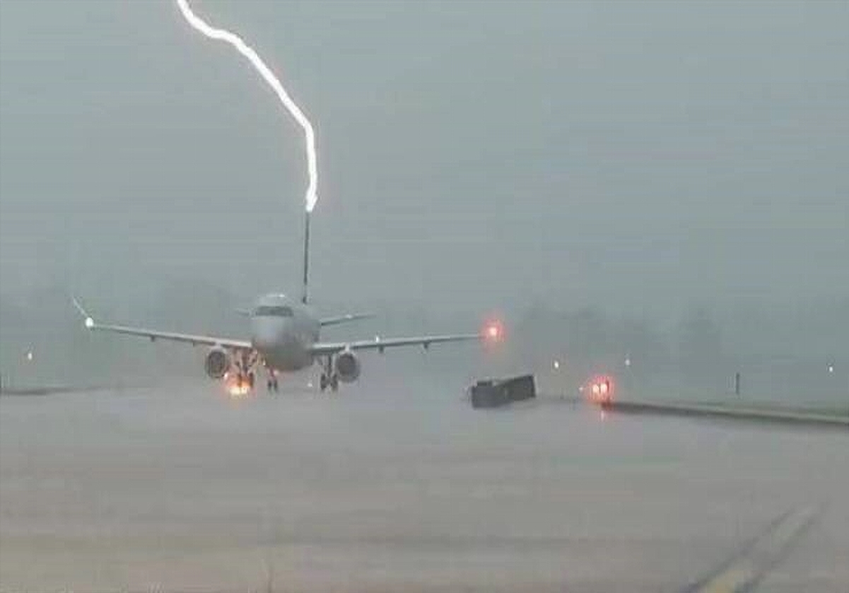 Lightning strikes a plane's tail.