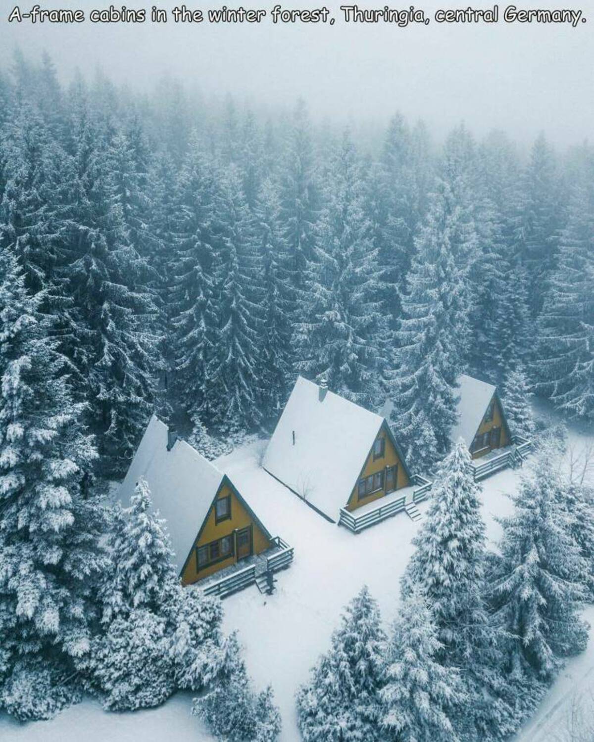 winter - Aframe cabins in the winter forest, Thuringia, central Germany.