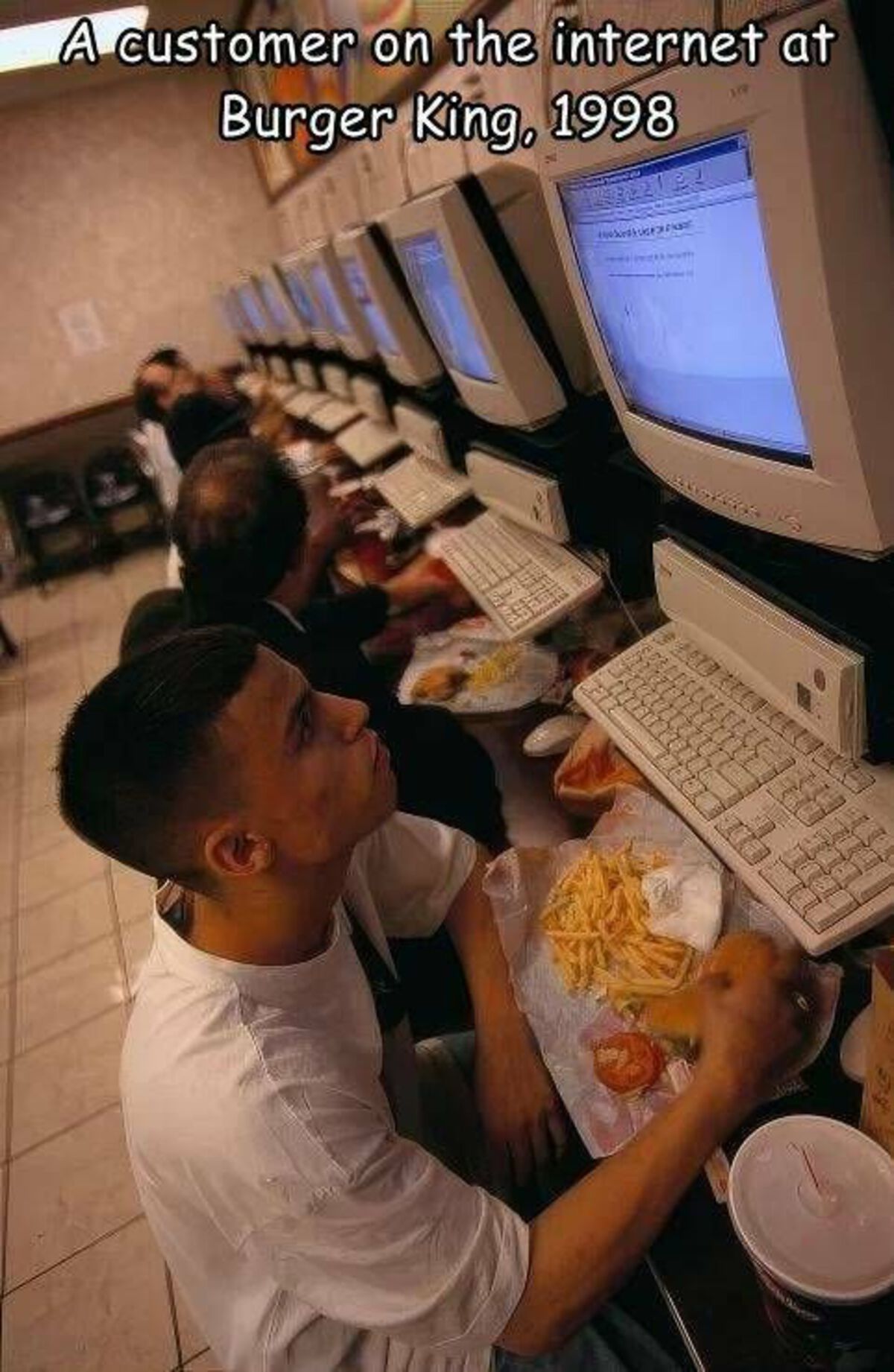screen - A customer on the internet at Burger King, 1998 An