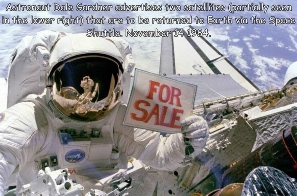 sale astronaut - Astronaut Dale Gardner advertises two satellites partially seen in the lower right that are to be returned to Earth via the Space Shuttle. . For Sale
