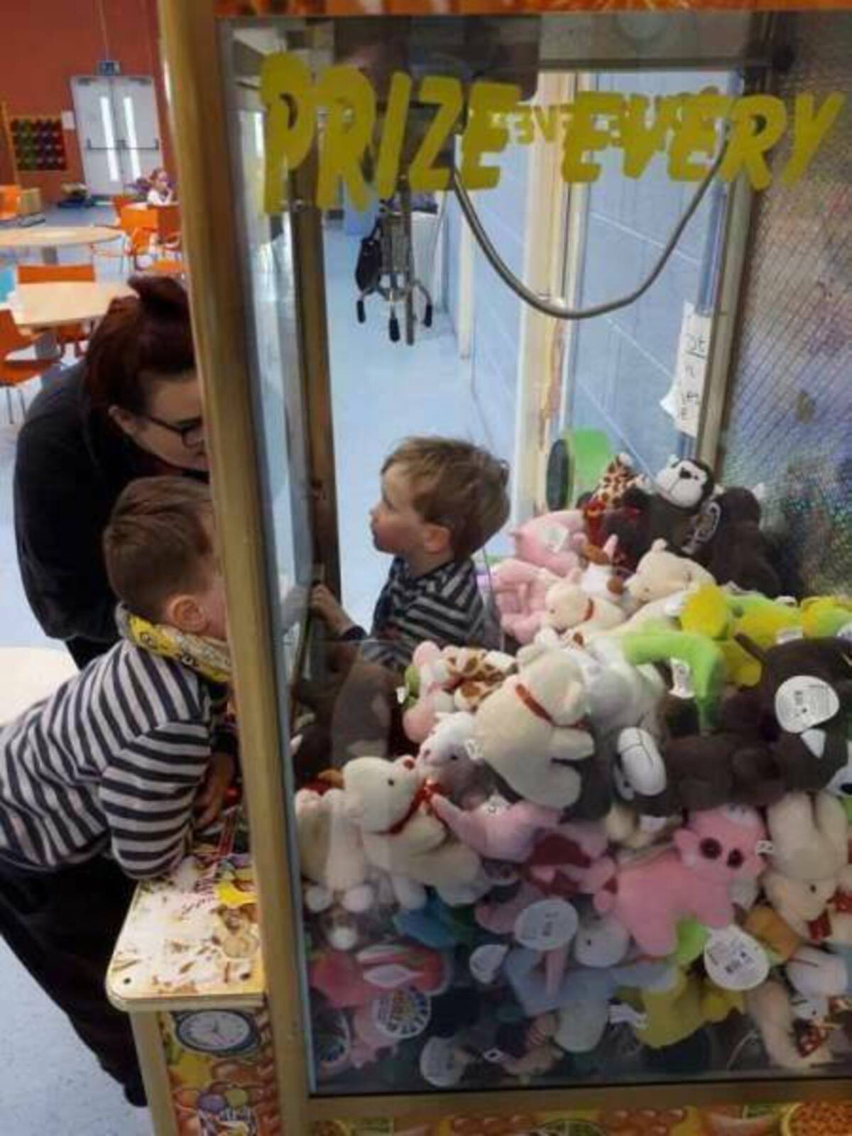 kid climbs in claw machine - Prize Every