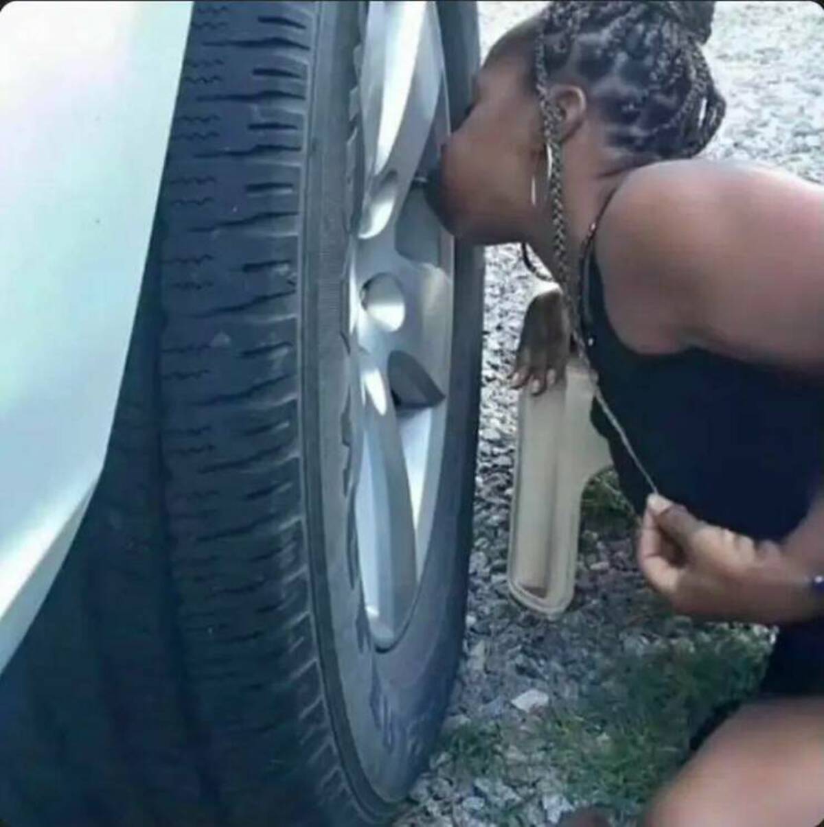 girl blowing up tire with mouth