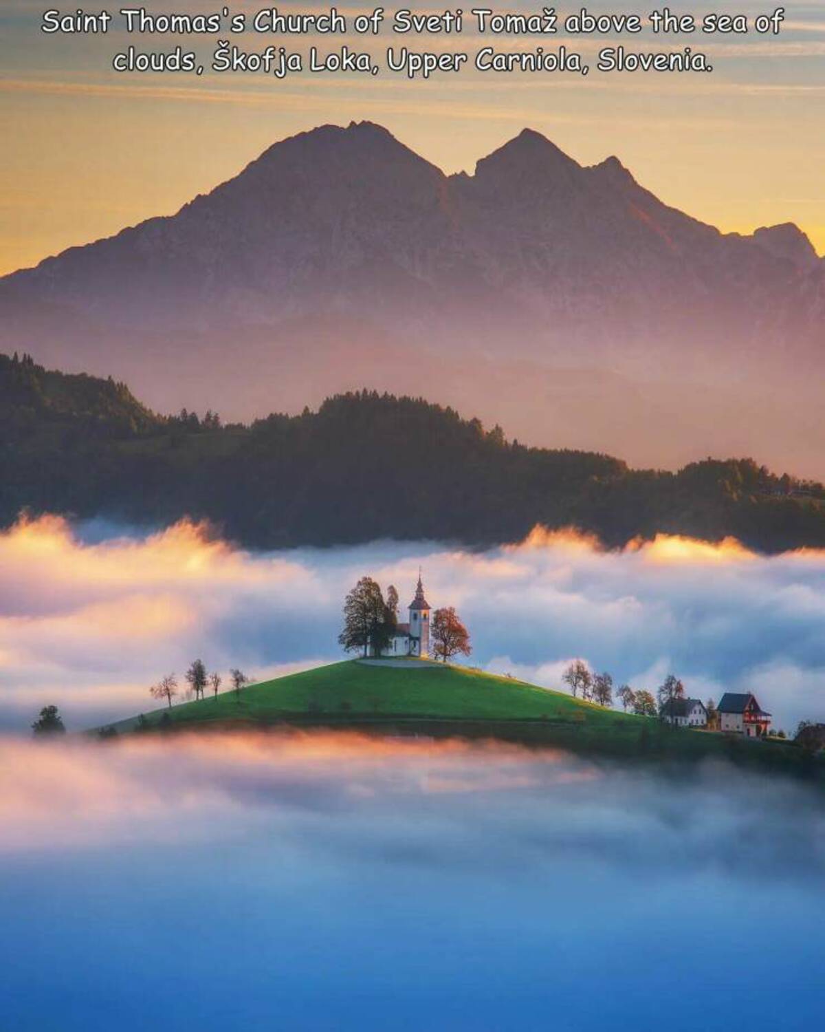 reflection - Saint Thomas's Church of Sveti Toma above the sea of clouds, kofja Loka, Upper Carniola, Slovenia.