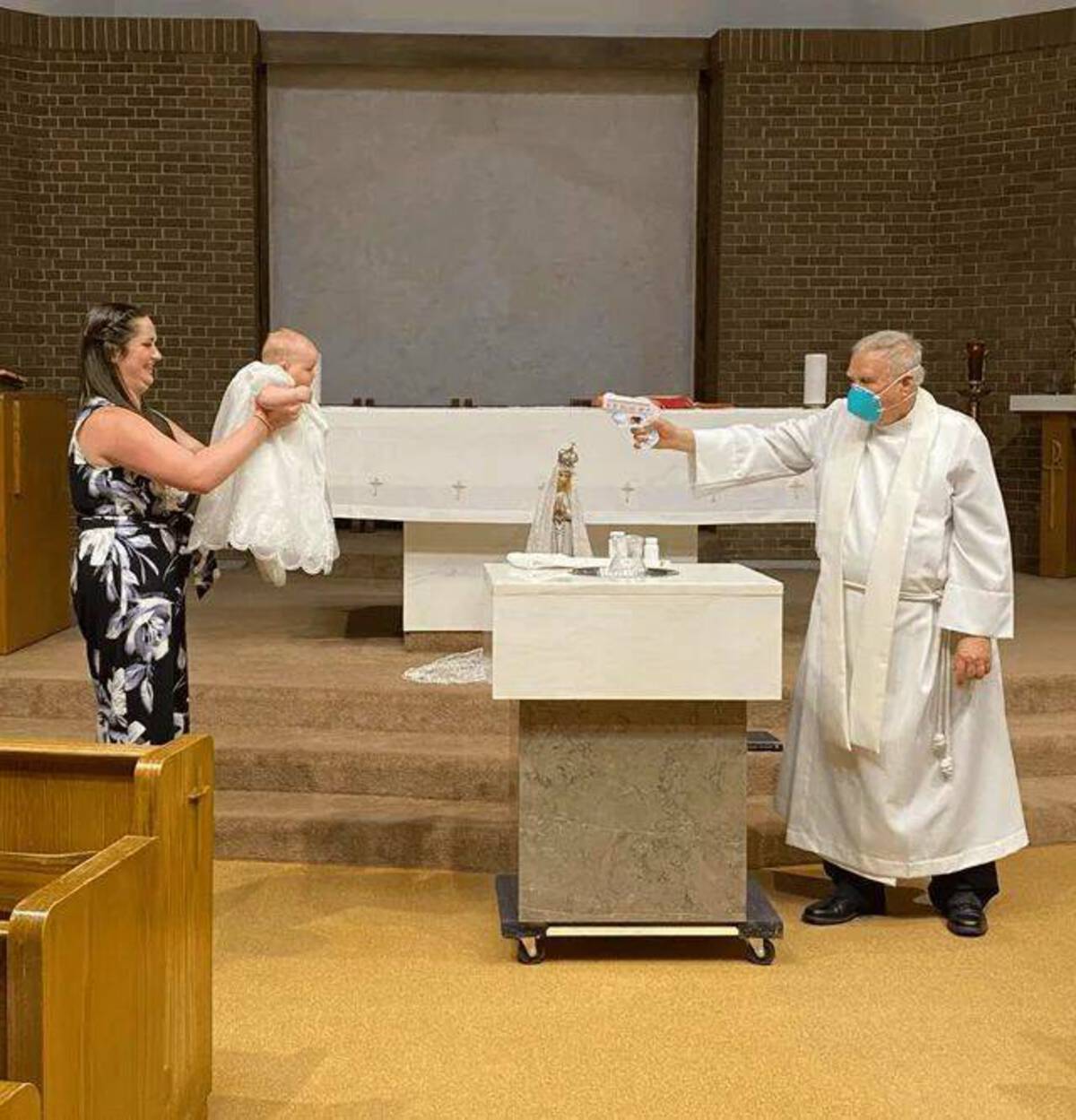 priest water gun baptism