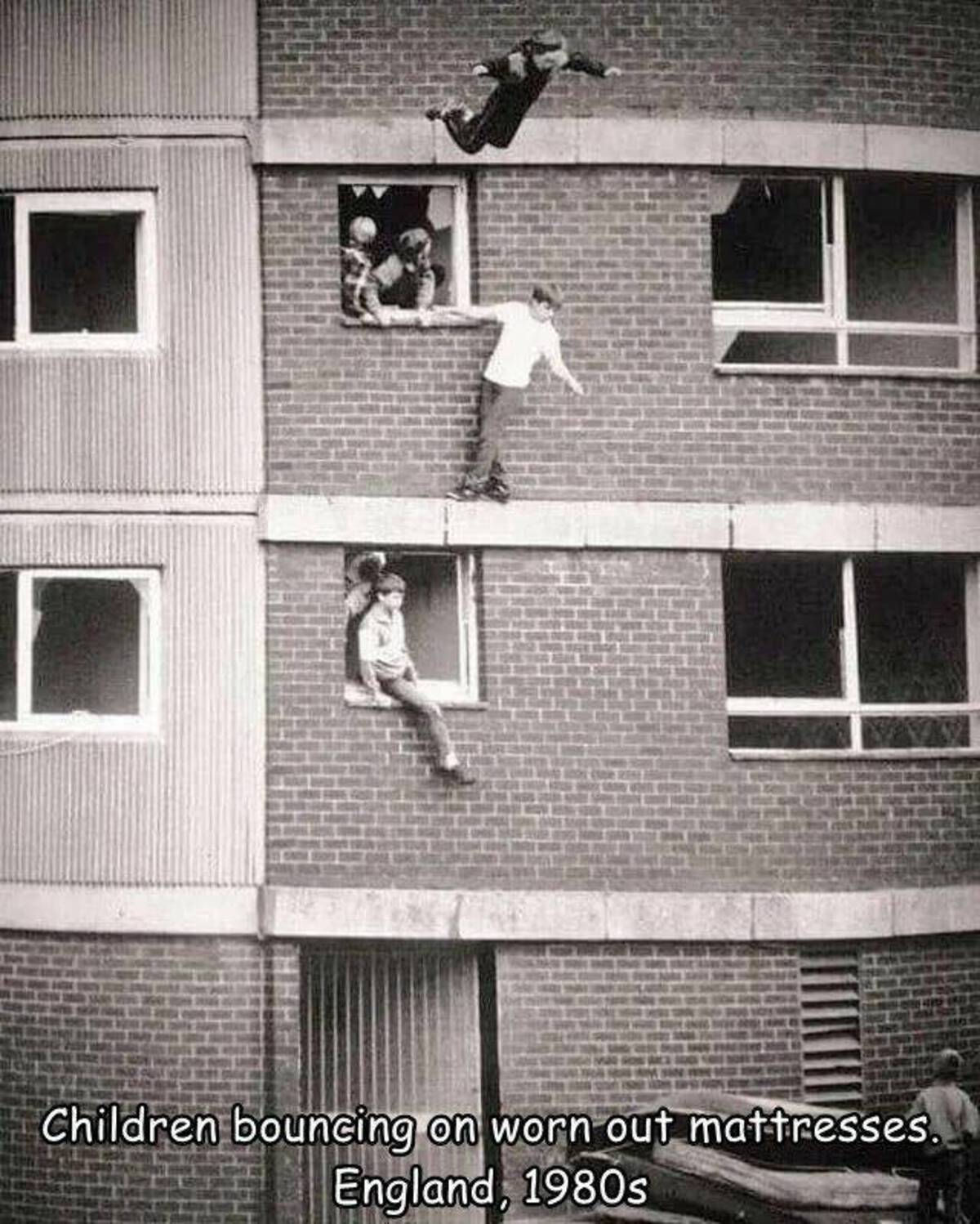 kids jumping onto mattress - Children bouncing on worn out mattresses. England, 1980s