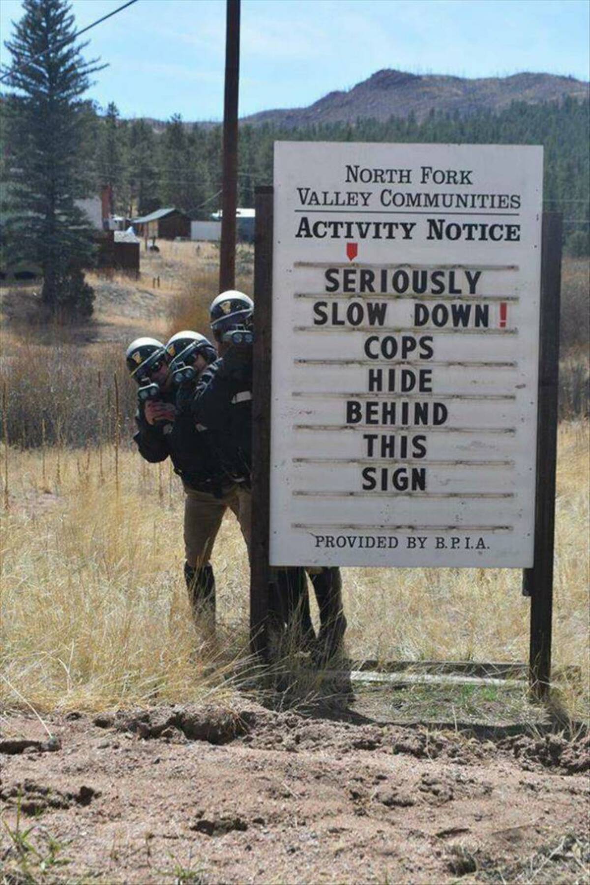 sign - North Fork Valley Communities Activity Notice Seriously Slow Down! Cops Hide Behind This Sign Provided By B. P. I.A.