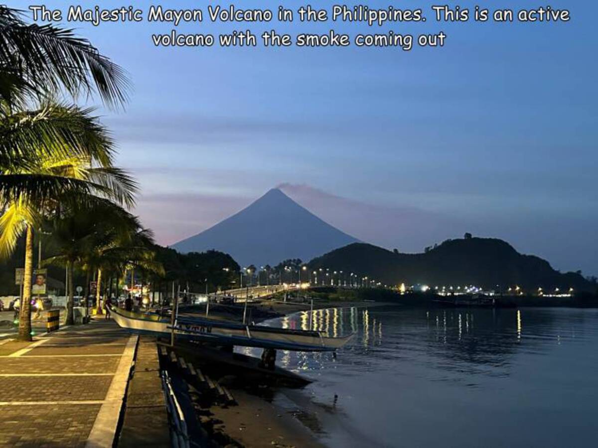 attalea speciosa - The Majestic Mayon Volcano in the Philippines. This is an active volcano with the smoke coming out